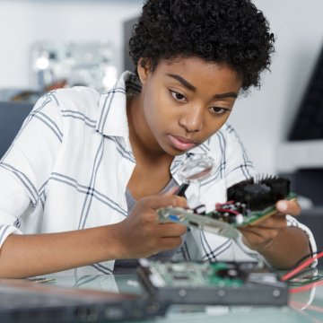 Woman fixing a computer